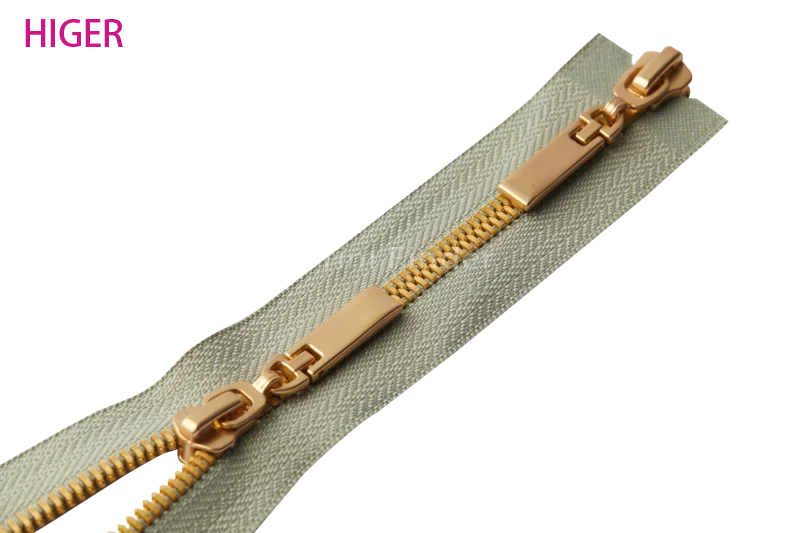 two-way zipper with dual circular pullers on zipper tape, HIGER logo in magenta.